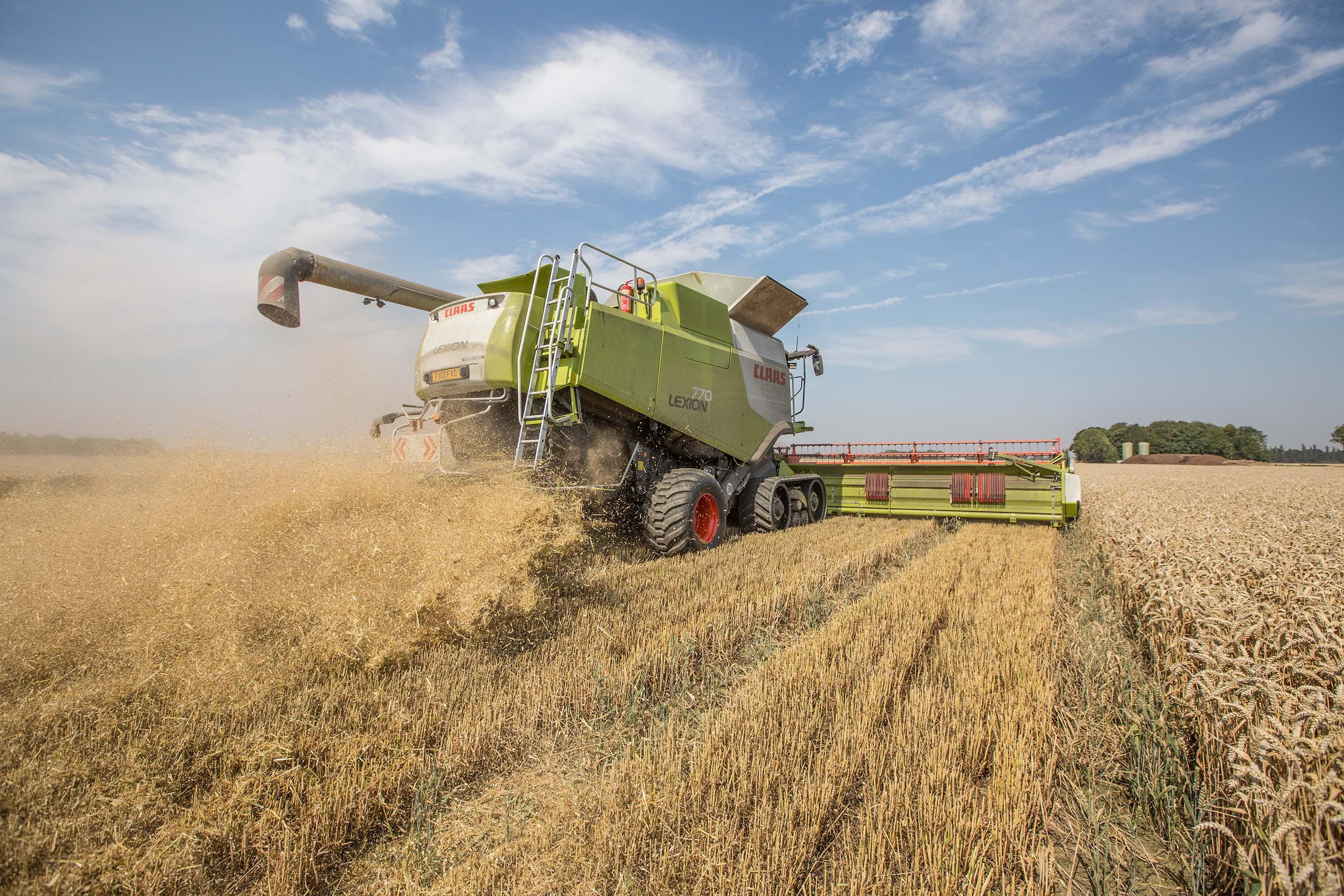 An image of a combine harvester at work in a Lincolnshire field.